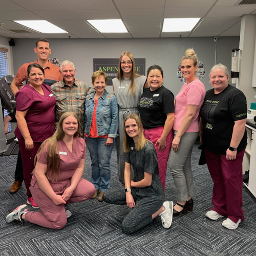 Aspen Ridge Staff smiling in a group together, happy to help their community with physical therapy treatments